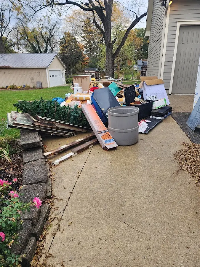 Dumpster being loaded with debris for Estate Cleanout Dumpster Rental in Albion